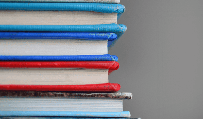 a stack of books to represent ways in which a school strategic plan benefits the community