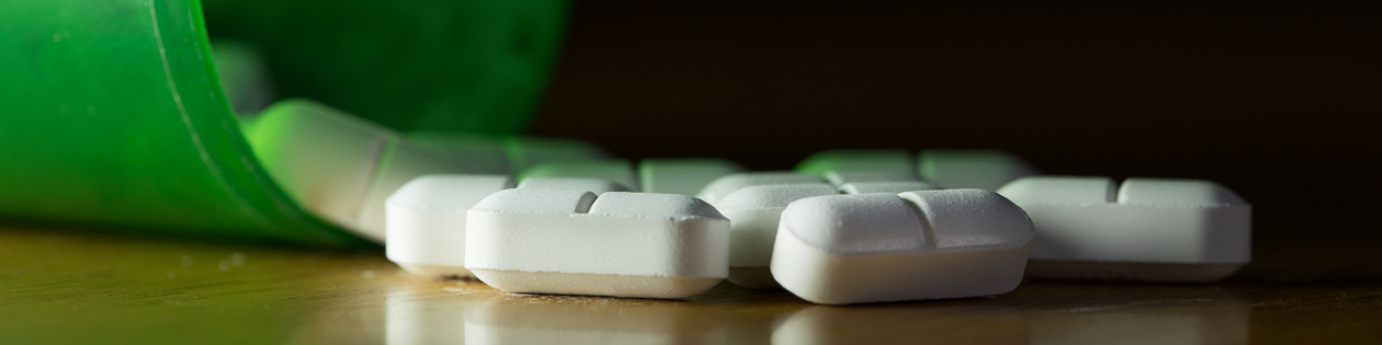 Image of pill bottle and pills representing opioid response strategic plans