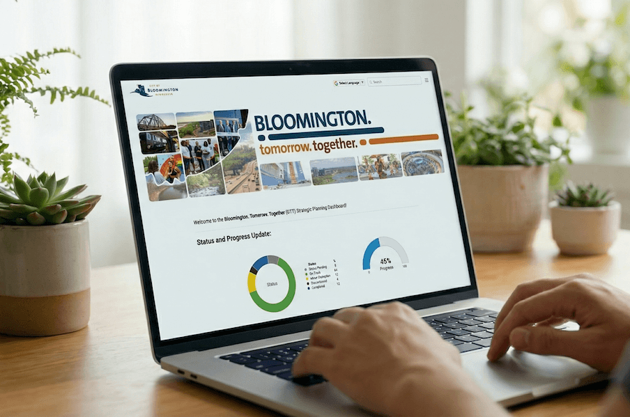 Photo of someone using a laptop with a local government dashboard image in the browser.