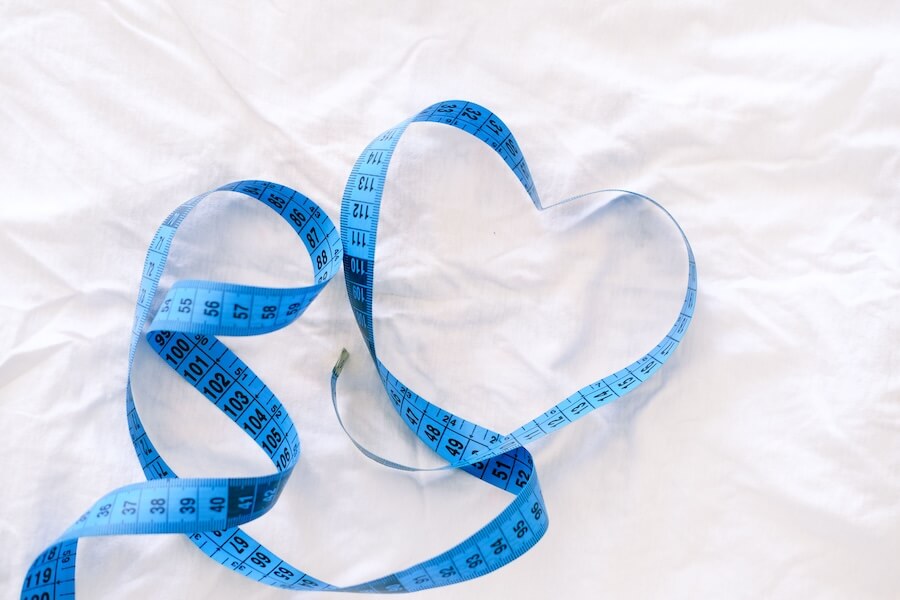 Image of a blue tape measured shaped into a heart.