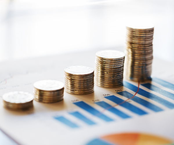 Stacks of coins compared against lines on a chart, signifying planning and budgeting in local government.